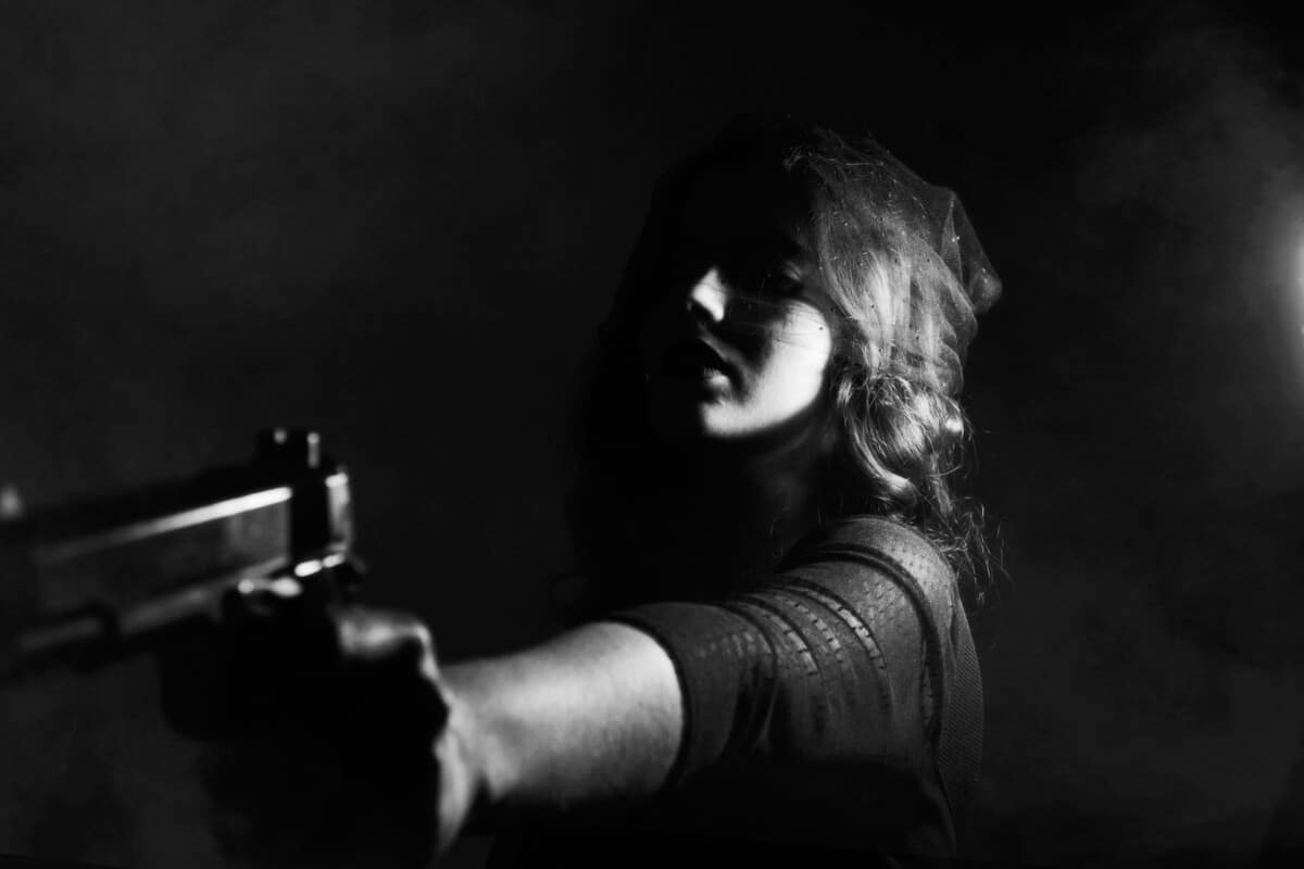 girl holding a pistol