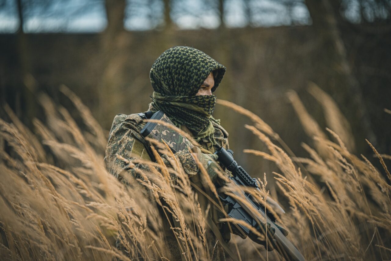 female airsoft player in knitted head scarf